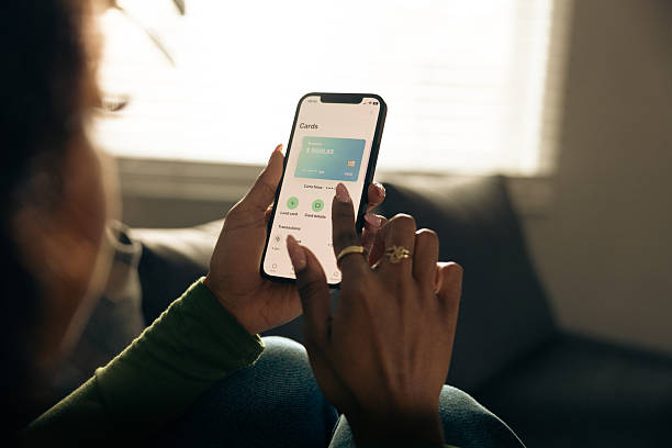 istock Close-Up of Woman Using Smartphone at Home 2255407649