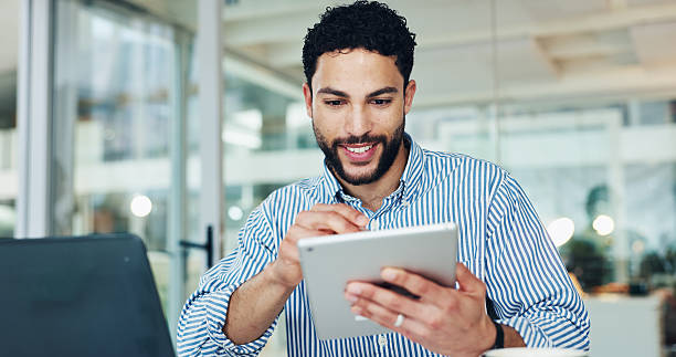 istock Business, man and reading with tablet in office for research, email editor and proofreading. Male journalist, digital and editing online with article feedback, update draft and publication submission 2255408751