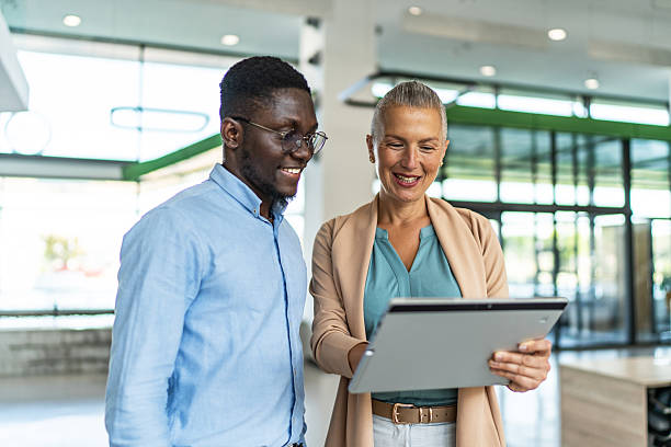 istock Business colleagues collaborating on digital tablet in modern office 2255411857