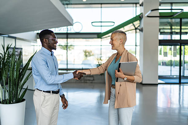istock Business people shaking hands in modern office building 2255412049