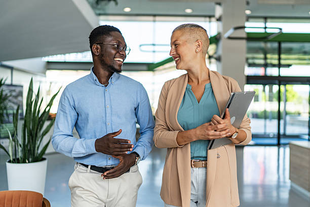istock Diverse business colleagues walking and talking in office 2255412069