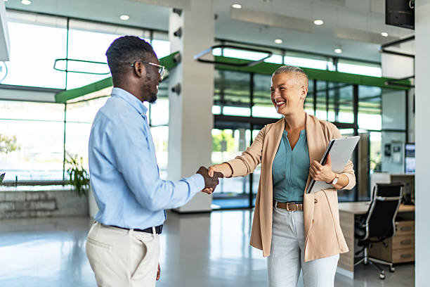 istock Business people shaking hands in a modern office 2255412121