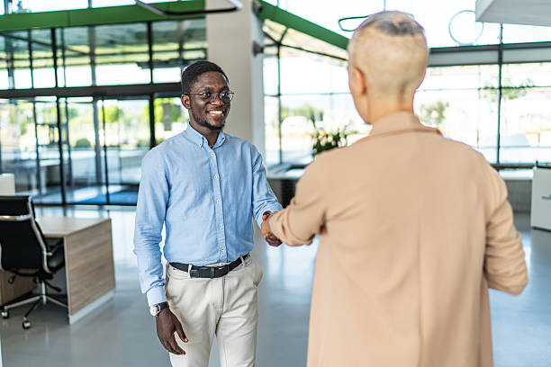 istock Business colleagues shaking hands making agreement in office 2255412214