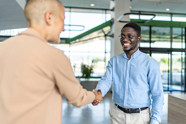istock Diverse businessmen making a deal with handshake in office 2255412224