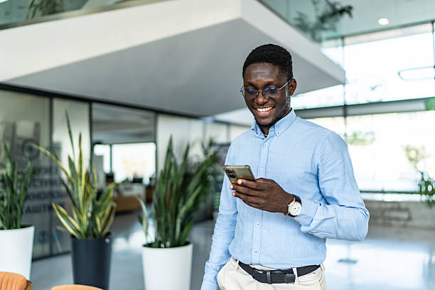 istock Happy young businessman using smartphone in modern smart office 2255412295