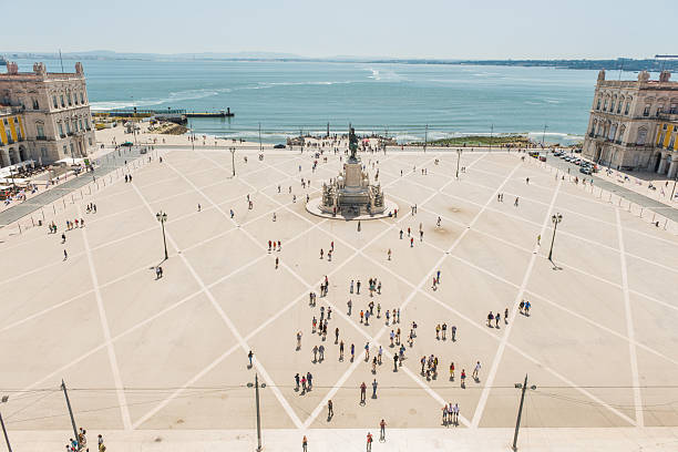 Panoramic aerial view over the landmarks and terracotta rooftops of Baixa and Praca do Comercio to the blue waters of the Tagus in the heart of Lisbon, Portugal’s vibrant capital city.