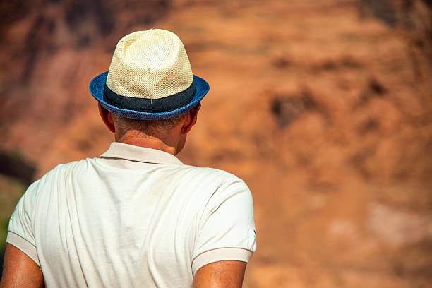 A man visiting the famous Horseshoe Bend Canyon on a summer day.