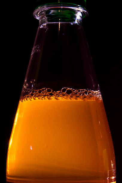 This vibrant drink showcases the rich color and texture of a sparkling liquid against a shadowy setting, ideal for promotional materials