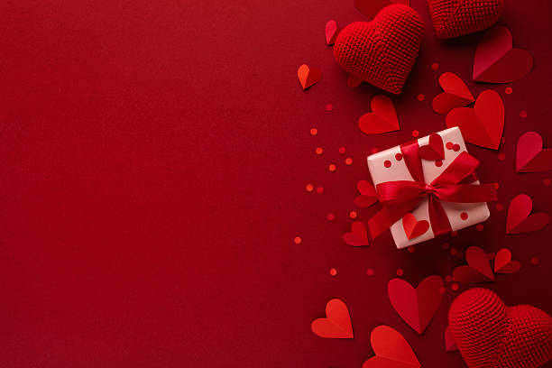 istock Valentine day background with red hearts and gift box flat lay. 2255426435