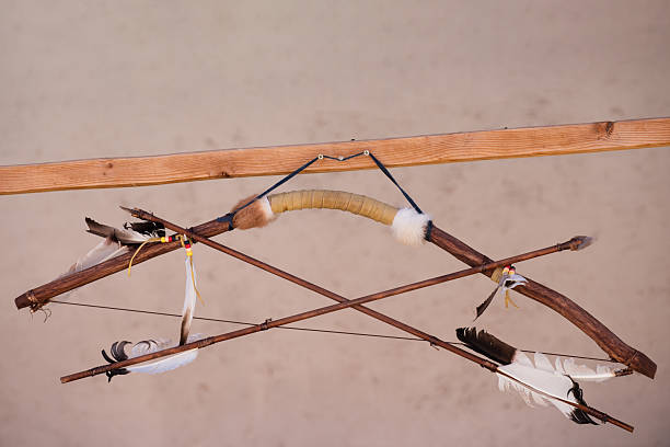 Bow craftsmanship reflects native heritage. Bow traditional archery culture. Bow craftsmanship handmade weapon history. Bow craftsmanship expresses tribal hunting tradition