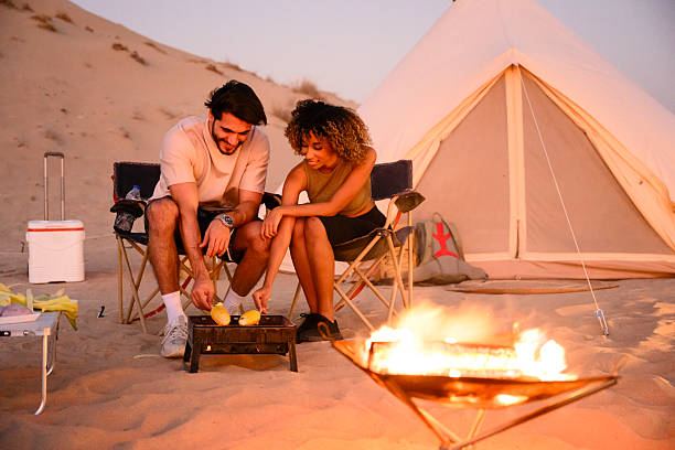 istock Young couple glamping in desert enjoying barbecue 2255429493