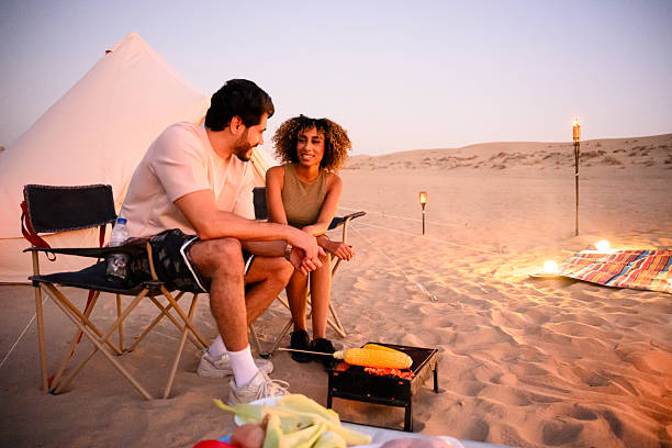 istock Couple enjoying desert glamping with campfire at sunset 2255429494