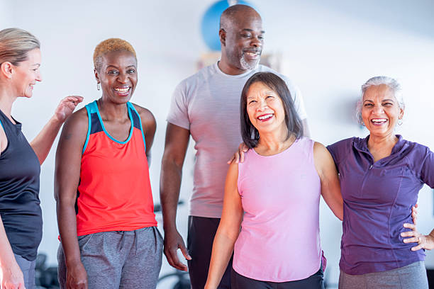 istock Diverse Group Of Happy Adults In Workout Studio Smiling And Posing Together 2255430907