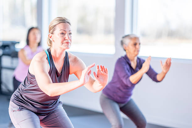 istock Group Yoga Class For Seniors: Diverse Women Practicing Balance And Focus In Bright Studio 2255430938
