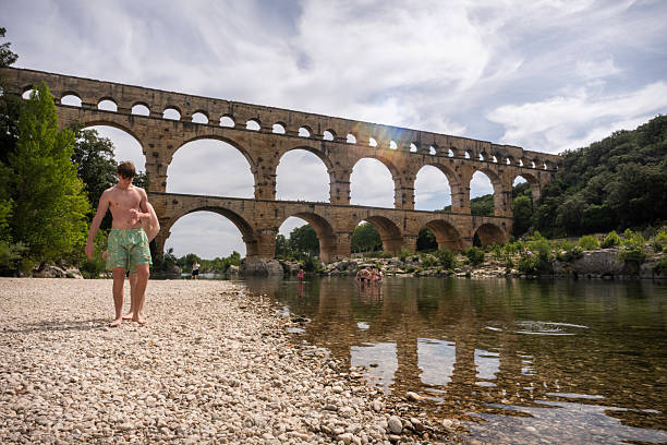 Pont du Gard, France - June 18, 2024: Tourists visit the ancient Roman aqueduct built in 1AD, which carried water 31 miles to Nimes, Provence
