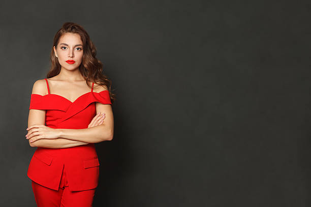 Pretty fair-haired woman in orange shirt - portrait shot on the black background