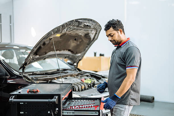 istock Car mechanics working in car workshop, choosing the tools from the toolbox 2255443918