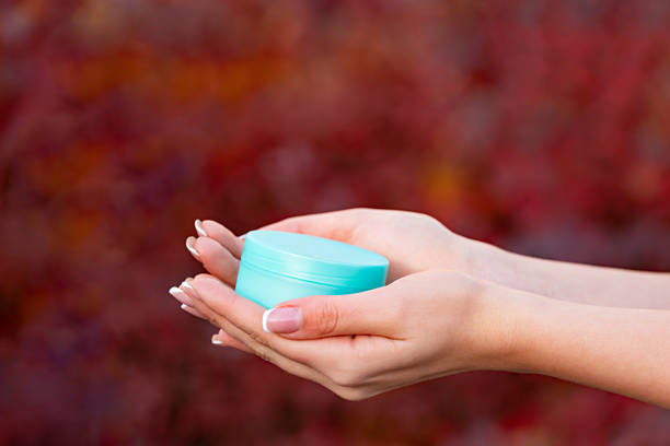 hands holding cream jar for skincare. cosmetic.