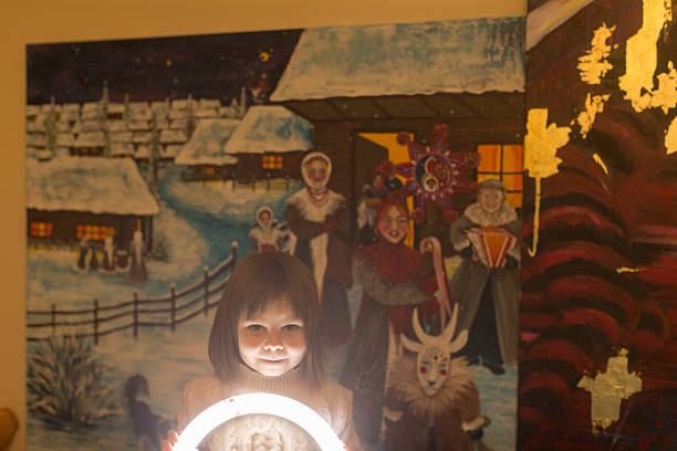 girl illuminated by circular glow creating dramatic shadow play against painted mural, playful spooky storytelling vibe with high contrast lighting and curious