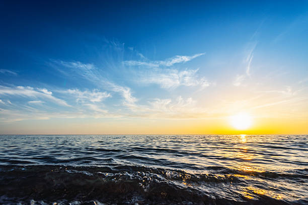 istock Sunset Over Calm Ocean with Golden Hour Sky, Waves, and Serene Horizon 2255449094