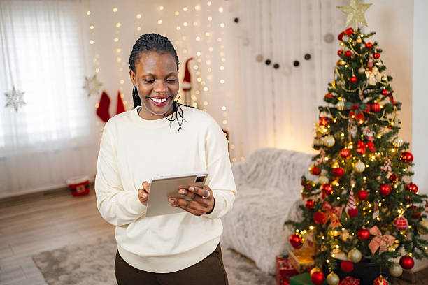 istock Smiling woman using digital tablet enjoying Christmas holidays 2255452166