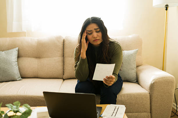 istock Stressed woman experiencing financial problems, looking at overdue bills and struggling with budget planning at home 2255458985