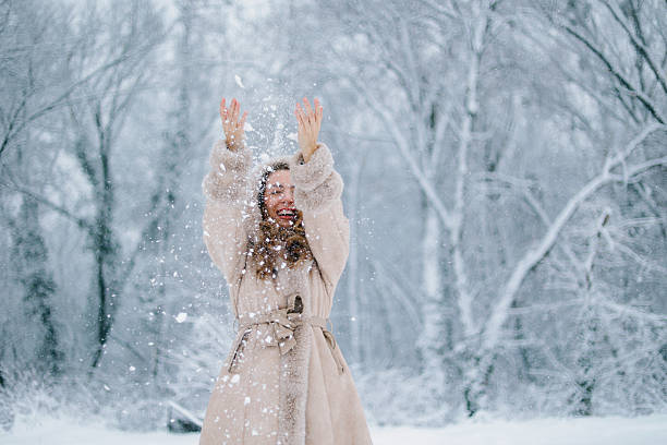 Beauty Woman laughing and having fun in winter park