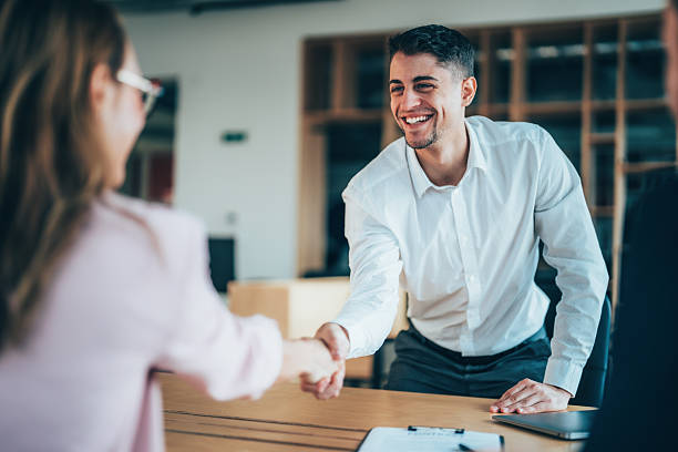 istock Business professionals shaking hands while attending a conference meeting 2255464248