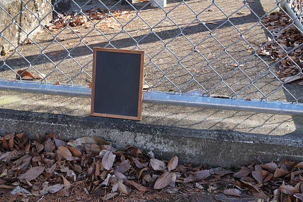 Black blank sheet is placed on located in front of a coffee shop. Blank wood sandwich board standing outdoor cafe, mockup menu advertising design.. High quality photo