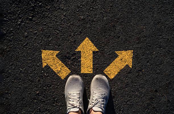 istock Choice concept with person standing before three yellow arrows represents decision making direction career path options future planning uncertainty confidence and taking the right step forward. 2255468063