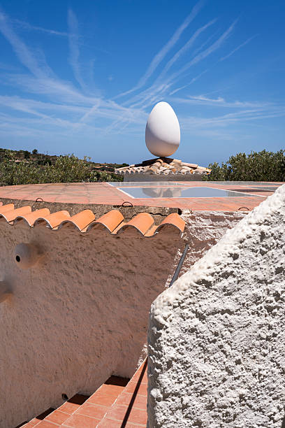 Port lligat, Spain - July 5, 2024: Egg sculpture at the garden of the summer house of the painter Dali in Portlligat, a small village on the Costa Brava of the Mediterranean Sea, in the municipality of Cadaques, Girona, CataloniaSalvador Dali home where he lived 50 years in the bay of Port Lligat in the small fishing village of Cadaques on the Costa Brava, Girona, Spain