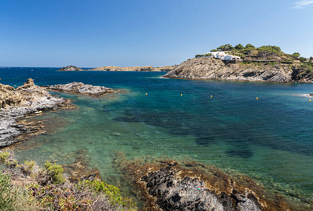 Port lligat, Spain - July 5, 2024: People hiking on the trail in Cap de Creus Natural Park along the rocky Costa Brava, the easternmost point of Catalonia Spain near Cadaques, Girona