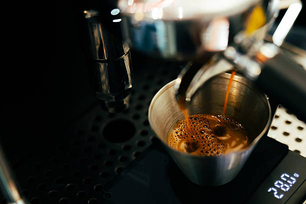 Brewing fresh espresso coffee in coffee shop.