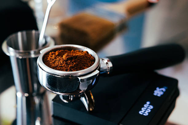 Brewing fresh espresso coffee in coffee shop.