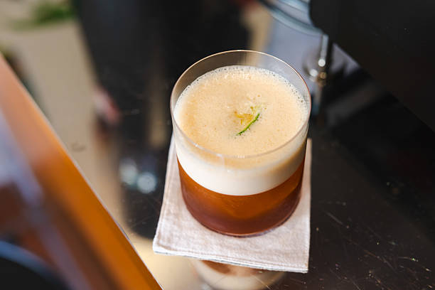 Cold brew fresh coffee is serving with ice and lime zest.