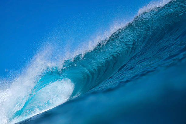 istock Clear Sky And Sharp Sunlight Illuminate Massive Turquoise Coastal Wave In Motion 2255481611