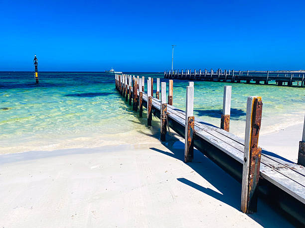 istock Weathered Wooden Jetty Extending Into Tropical Ocean Under Clear Sky 2255488785