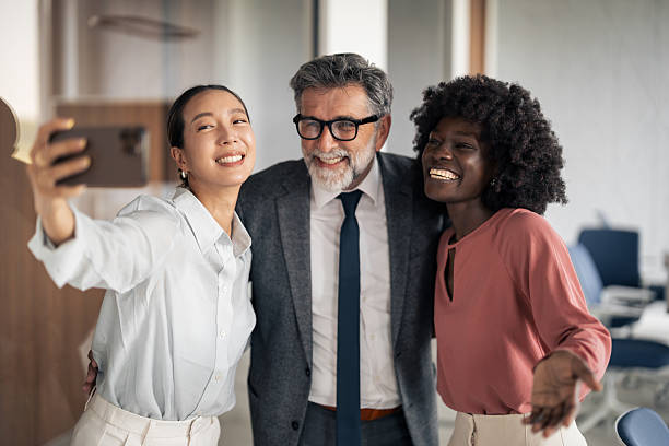 istock Diverse business team taking selfie in modern office 2255499619