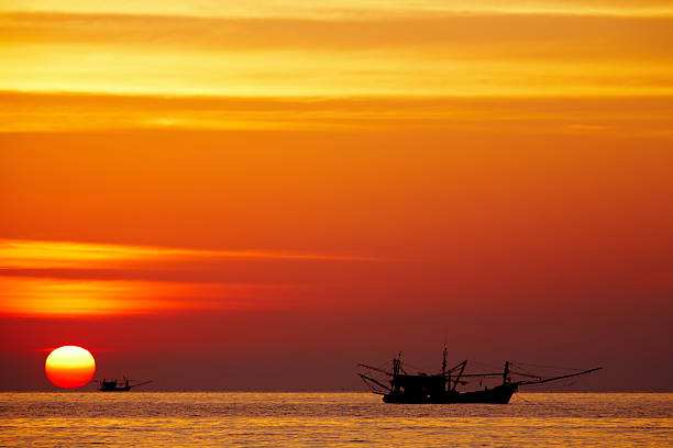 Seascape with fishing boats at sunset, Chang island, Thailand