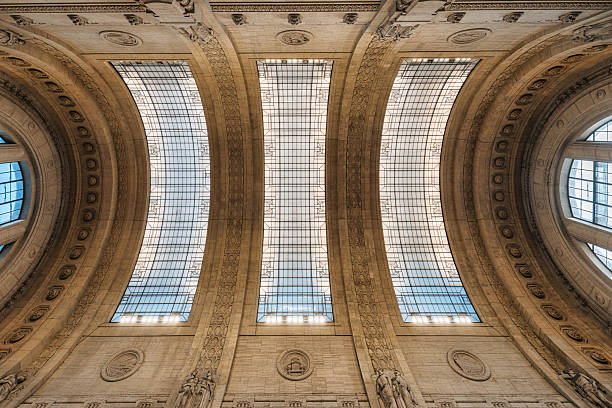Upward view of detail architectural interior of grand arched classic ceiling and sculpted stone in Milano centrale, Milan, Italy