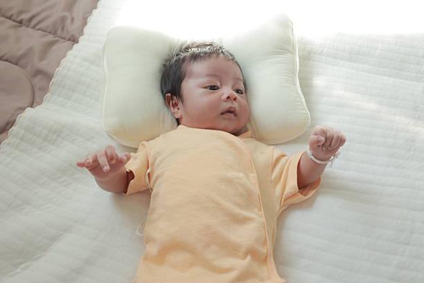Newborn baby boy sleeping on the bed, little baby
