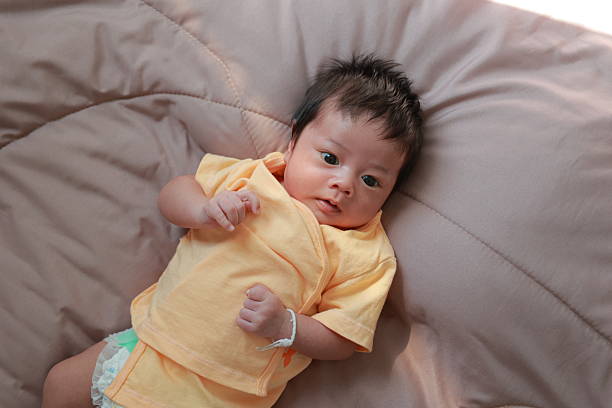 Newborn baby boy sleeping on the bed, little baby
