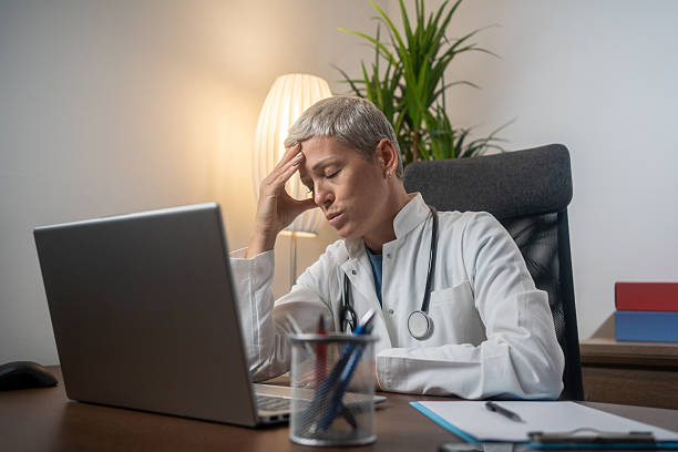 istock Overworked female doctor in her office. 2255509609