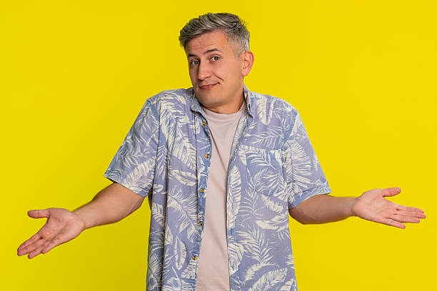 istock Adult man shrugging shoulders with confused expression raised hands showing he does not know answer 2255517281