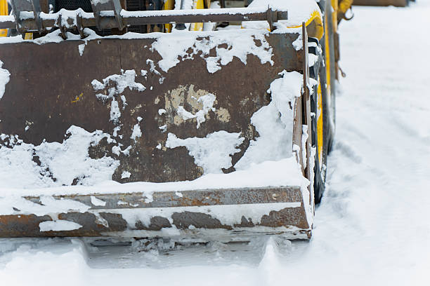 istock ndustrial loader bucket detail featuring worn metal surface rust marks and snow deposits positioned on winter worksite ground 2255520443