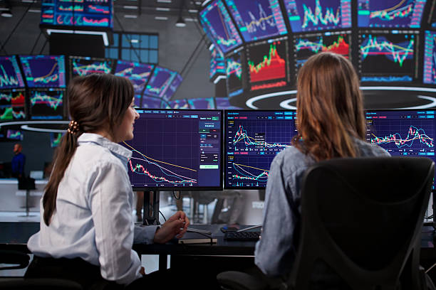 istock Female Stock Broker Analyzing Market Graphs 2255527570