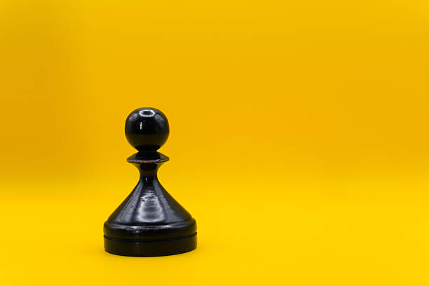 A black pawn whose shadow is the queen. Business and strategy concept.