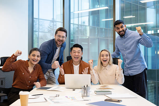 istock Team celebrating a success together in a modern office environment 2255533346