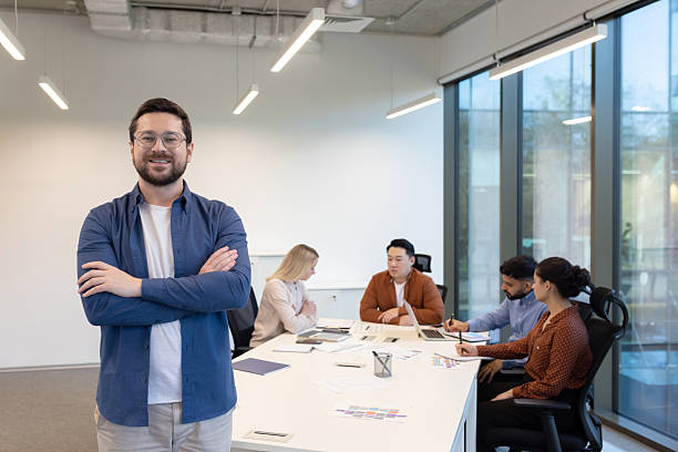 istock Confident businessman with his team in a modern office setting, engaged in a meeting. 2255533463