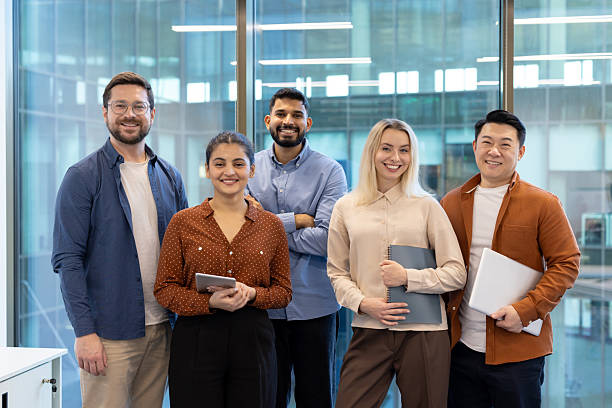 istock Group of diverse professionals smiling in a modern business office setting 2255533491